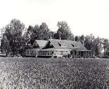 The photo dates from circa 1927 after the completion of the addition to the ranch house. The addition with its glazed porch is at the rear left hand side.; Glenbow Museum NA-460-22