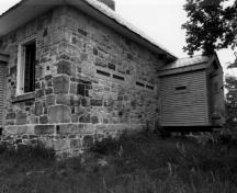 Corner view of the Jones Falls Defensible Lockmaster's House, showing the frame defensible porch, 1989.; Parks Canada Agency / Agence Parcs Canada, 1989.