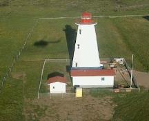 General view of Cape Anguille Light Tower, showing the tapered, octagonal form of the light tower consisting of a tall concrete shaft surmounted by a small lantern, 2000.; Department of Fisheries and Oceans / Ministères des Pêches et Océans, 2000.