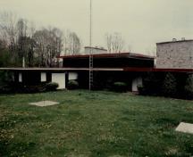General view of the Cottage, showing the single storey, horizontal massing and the tripartite composition, 1989.; Environment Canada / Environnement Canada, 1989.