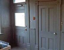 Interior view of the Lockmaster's House, showing the woodwork and the waist-high wooden wainscotting, 1989.; Parks Canada Agency / Agence Parcs Canada, 1989.