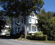 This front and side corner view details the verandah and front portico.; PNB 2004