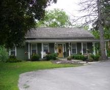 Of note is the symmetrical facade with wraparound porch.; Kirsten Pries, 2008.